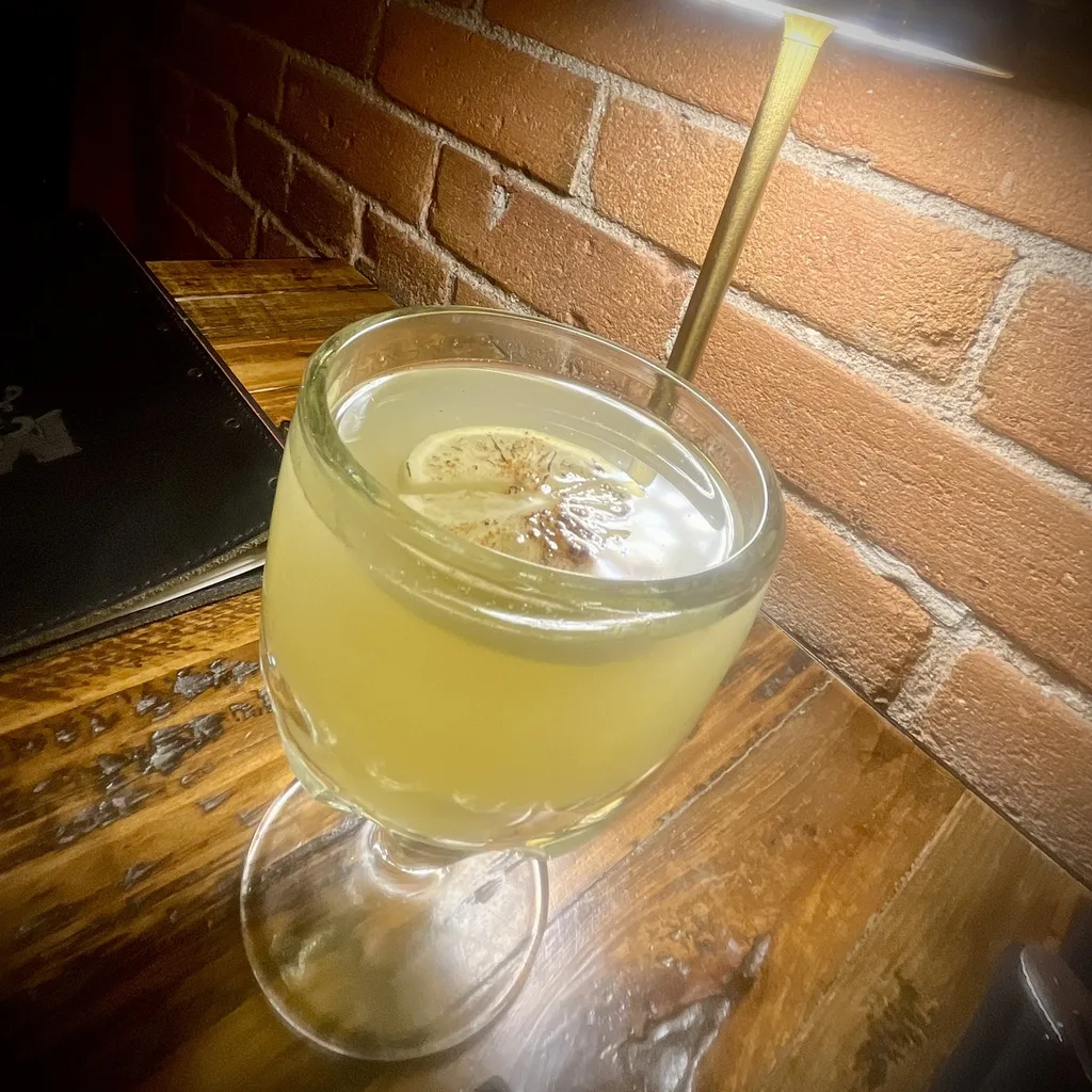 Kitchen team plating a dish with care