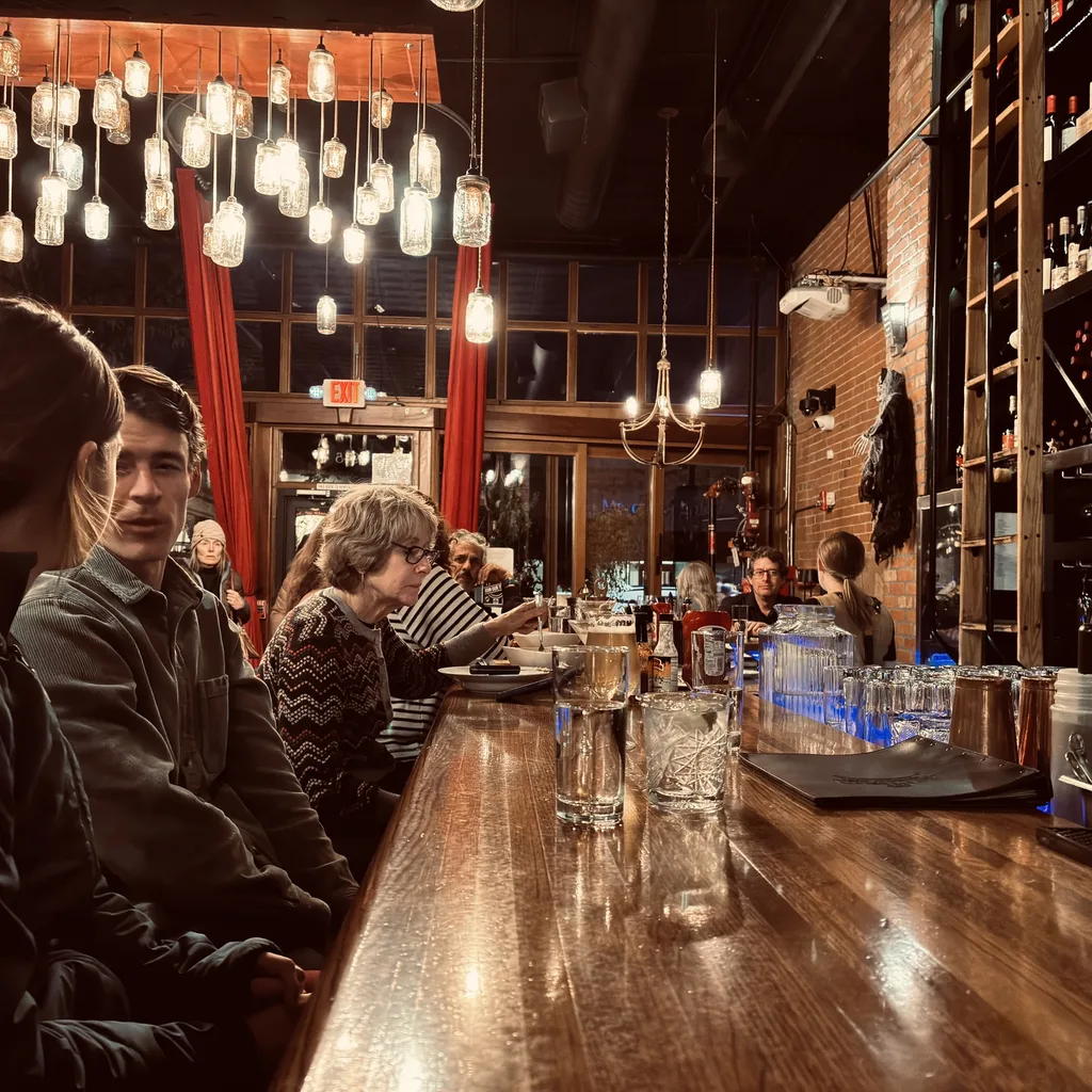 Guests enjoying cocktails at the bar